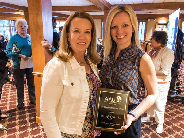 Two women lawyers holding a plaque award from the American Association of University Women