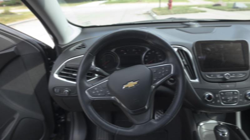 Blurry image of a drivers wheel inside a car symbolizing operating while visibility impaired (OWVI)