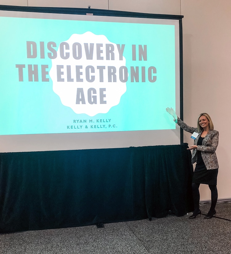 Ryan Kelly, a young blonde family law attorney presenting on a projector screen with the title "discovery in the electronic age."