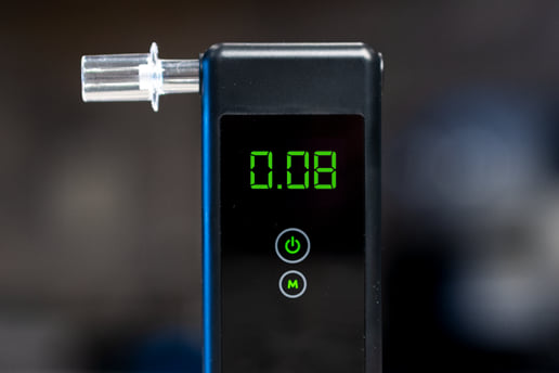 Close up of a breathalyzer showing a 0.08 reading