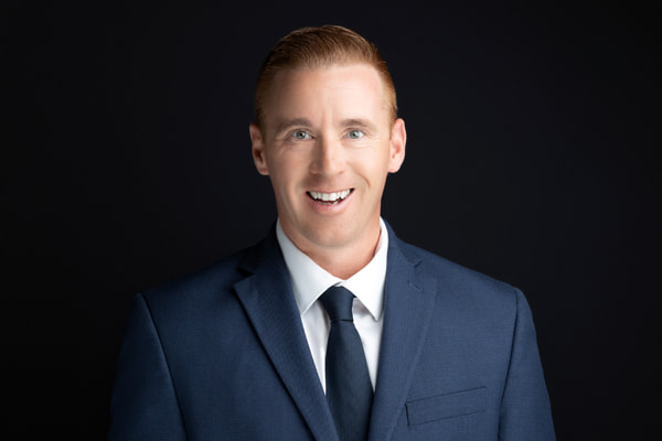Mike Kelly, Criminal Law Attorney at Kelly & Kelly Law, professional headshot with black background